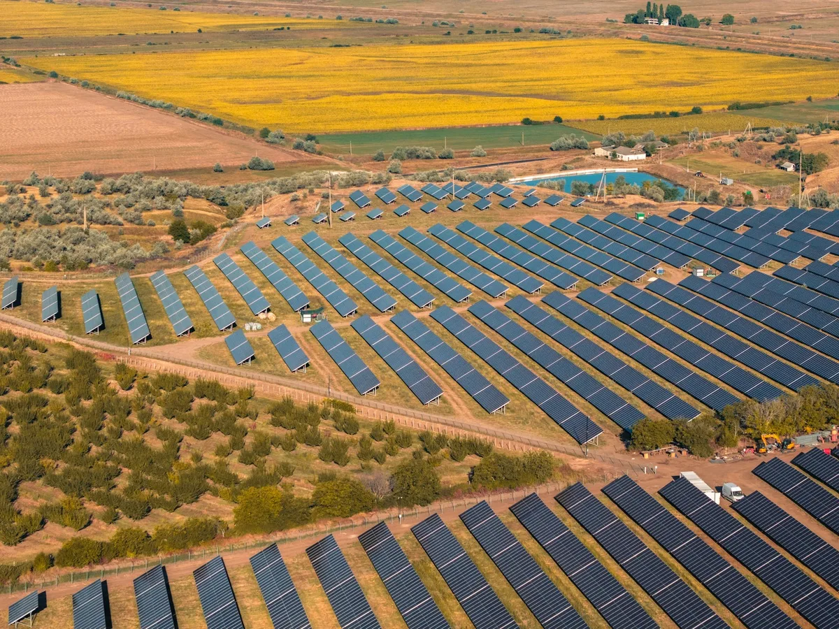 Aerial view of a utility-scale solar farm in a rural landscape